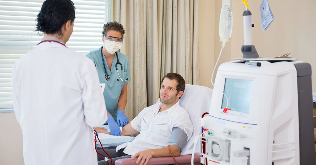 Medical team with patient undergoing renal dialysis treatment in hospital room; blog: 8 Coping Tips for Dialysis Patients