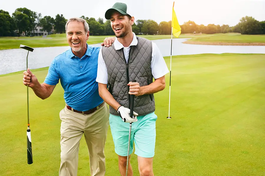 Father playing golf with his son after GAE procedure